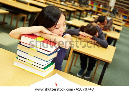 Students sleeping in reading room of university library