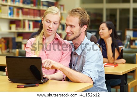 Student helping each other in a library