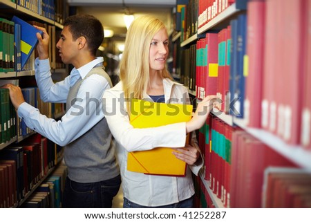 Two students doing research in a library