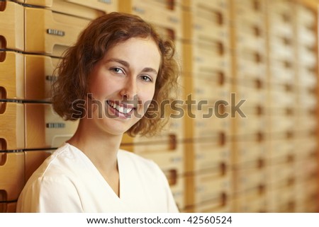 Female pharmacist at medicine cabinet in pharmacy