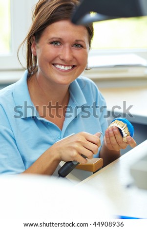 Dental technician milling a tooth for dentures