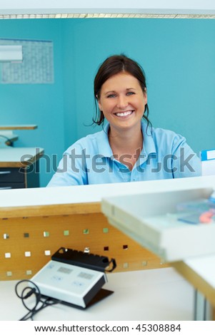 Happy dental technician working in dental laboratory