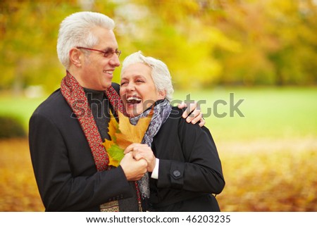 Happy senior couple in an autumn forest