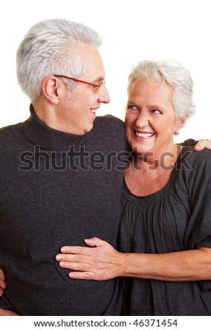 Happy senior citizen couple with grey hair embracing