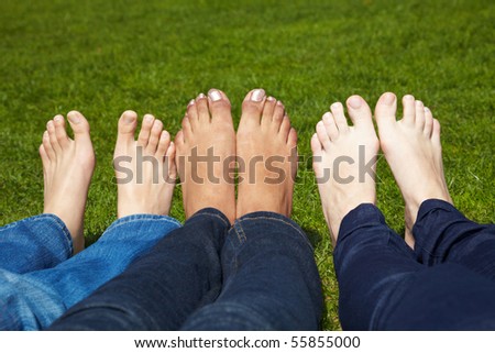 stock photo Three women with naked feet lying in grass stock photo Three women with naked feet lying in grass