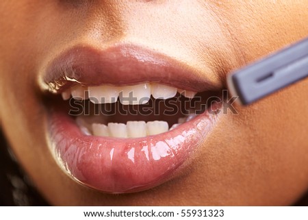 Closeup of an open mouth using a headset