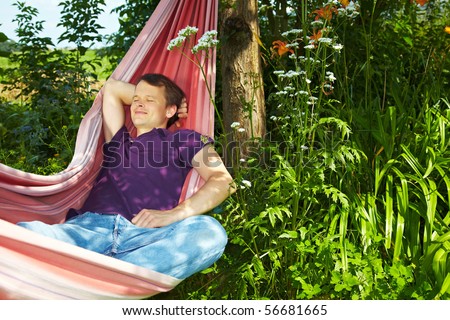 Young man sleeping relaxed in a hammock