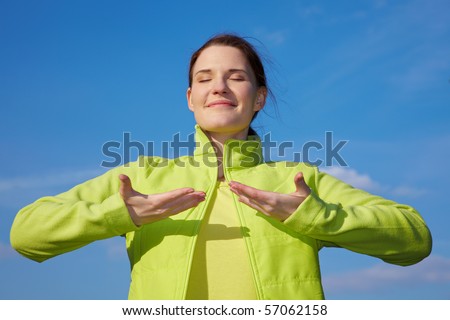 Young woman doing some breathing exercises outdoors