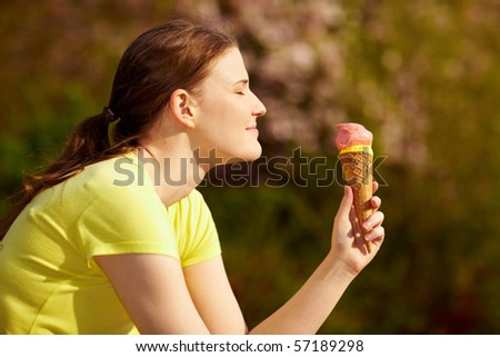 Happy woman eating an ice cream cone in summer