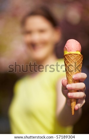 Happy woman eating an ice cream cone in summer