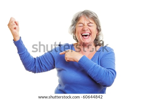 Happy female senior citizen showing her muscles