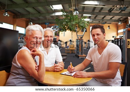 A fitness coach making a physical fitness program for two seniors