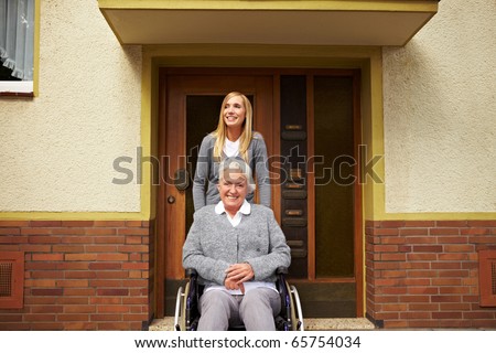 Smiling elderly woman in front of a retirement home