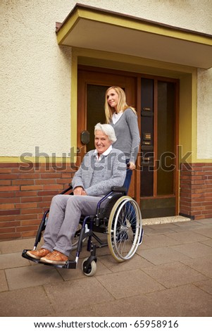 Smiling elderly woman in front of a retirement home
