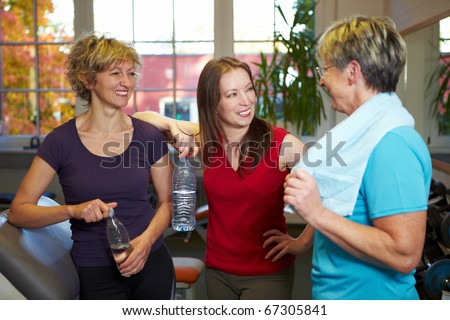 Happy elderly women talking in a gym