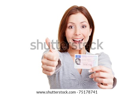 Happy woman with European driving license holding her thumbs up