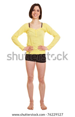 Young happy woman in sportswear with her arms akimbo
