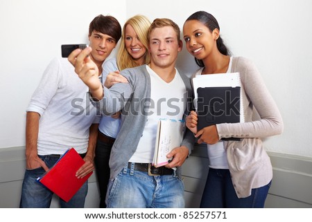 Happy teenagers taking group photo with smartphone