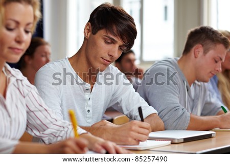 Students taking a test in university class