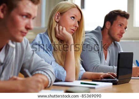 Female student with computer in university class