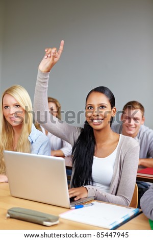 African student raising her hand in university class