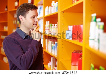 Pensive man shopping for products in a drugstore
