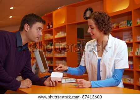 Pharmacist giving medical advice about medication to customer