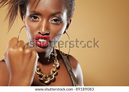 Angry young african woman clenching her fist