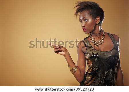 Young african woman pointing with her index finger to the left