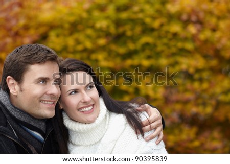 Happy smiling pensive couple in autumn thinking