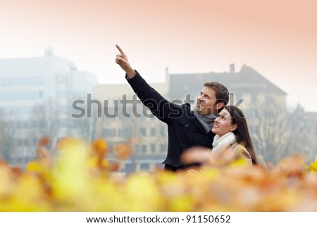 Two tourists on vacation discovering a city in autumn