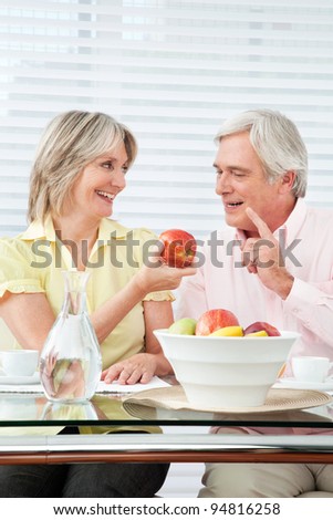 Senior couple having healthy breakfast with fruits and water