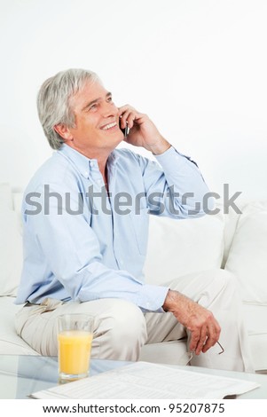 Happy senior man laughing on the phone
