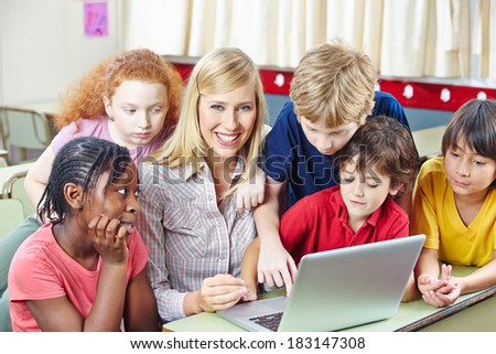 Children with teacher in computer science class in an elementary school