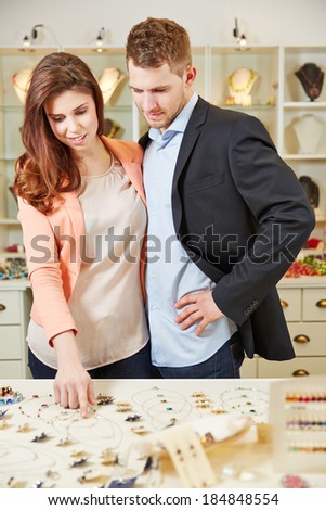 Couple shopping together in jewelry store for a necklace