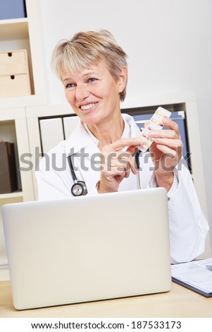 Elderly female doctor in her office recommending medication