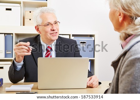 Consultant in bank making financial proposal to senior customer