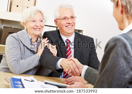 Senior couple giving handshake to consultant for a greeting
