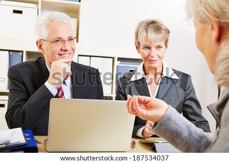 Elderly woman getting financial consultation in a bank