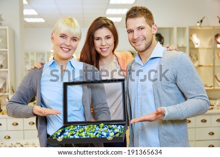 Happy staff team working together in a jewelry store