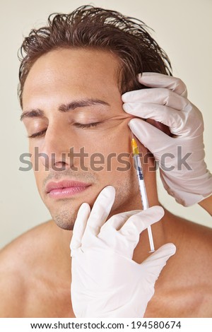 Man having crows feet removed in a beauty clinic with hyaluronic acid