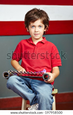 Boy playing xylophone in music class in elementary school
