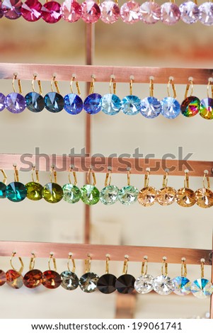 Many colorful earrings for sale in a jewelry store