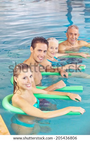 People doing aqua fitness as back training in a swimming pool