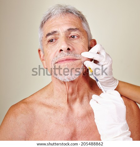 Old man getting wrinkle treatment with hyaluronic acid in beauty parlor