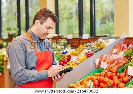 Store manager in supermarket using a mobile data registration terminal