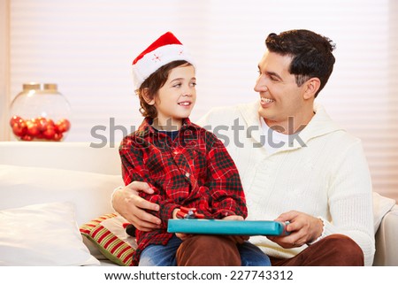 Father giving his son a gift at christmas eve