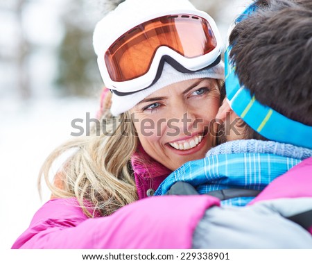 Happy Woman embracing man on ski trip in their winter holiday