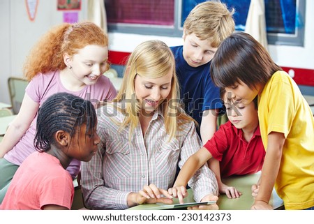 Teacher and students with tablet computer in elementary school class