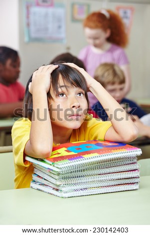 Japanese elementary school student in class with many notebooks